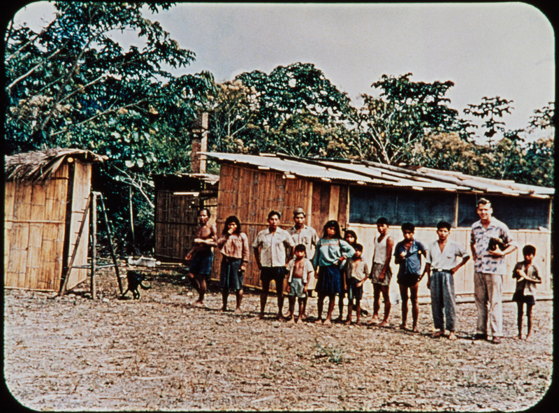 Ed McCully with Quechua Indians at Arajuno mission station, c. 1954-1955. Frame from <i>Mid-Century Martyrs</i> filmstrip developed by HCJB, Mission Aviation Fellowship, and the five widows in 1956.