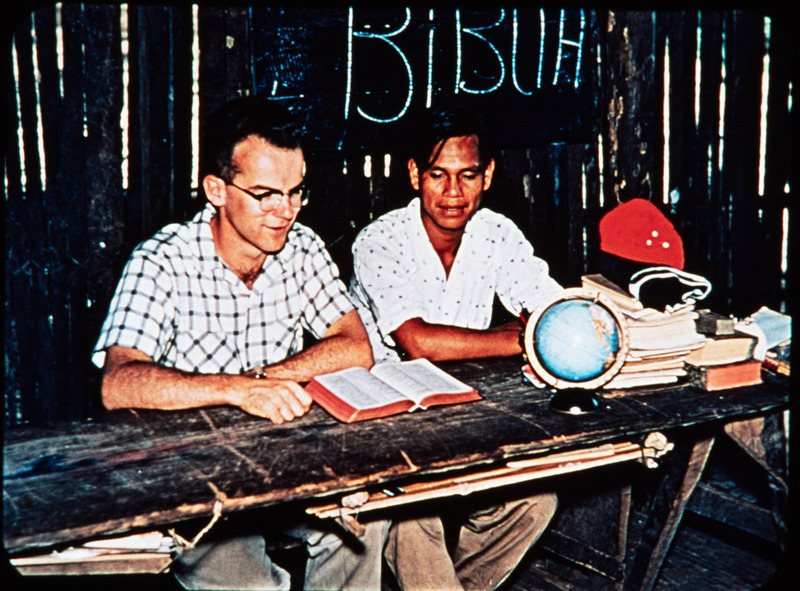 Image of Peter Fleming tutoring one of his Quichua students at Shandia or Puyupungu. Frame from <i>Mid-Century Martyrs</i> filmstrip developed by HCJB, Mission Aviation Fellowship, and the five widows in 1956.