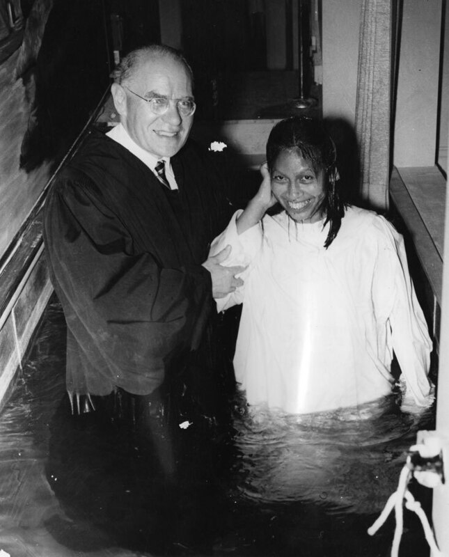 Photo of Dr. V. Raymond Edman baptizing Dayuma, an early Waorani convert, at the Evangelical Free Church in Wheaton, Illinois in April 1958.