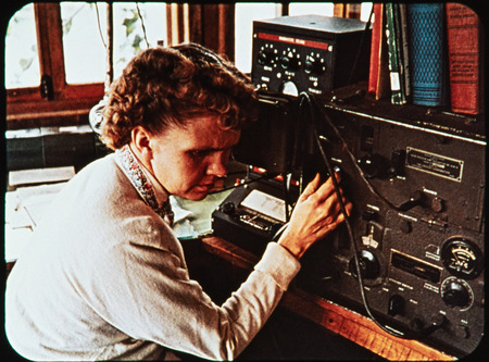 Image of Marjorie Saint at short wave radio in Shell Mera. Marjorie Saint oversaw the radio operations for Nate Saint's flights across the Ecuadorian Amazon. Frame from <i>Mid-Century Martyrs</i> filmstrip developed by HCJB, Mission Aviation Fellowship, and the five widows in 1956.