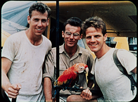 Image of Ed McCully, Peter Fleming, and Jim Elliot with parrot received from Waorani after one of Nate Saint's gift drops. Frame from <i>Mid-Century Martyrs</i> filmstrip developed by HCJB, Mission Aviation Fellowship, and the five widows in late 1956.